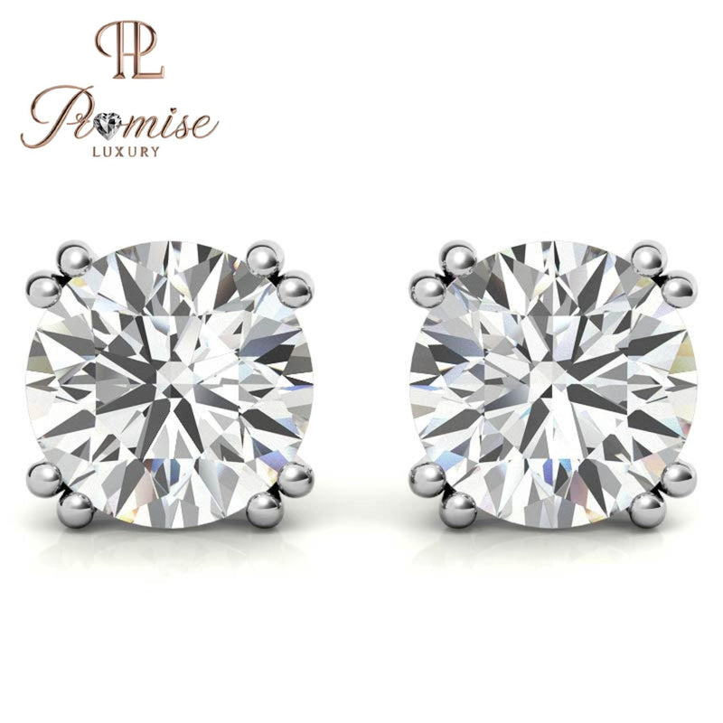 Stunning diamond floral stud earrings in 18K gold featuring a radiant center with a sparkling halo of brilliant round diamonds
